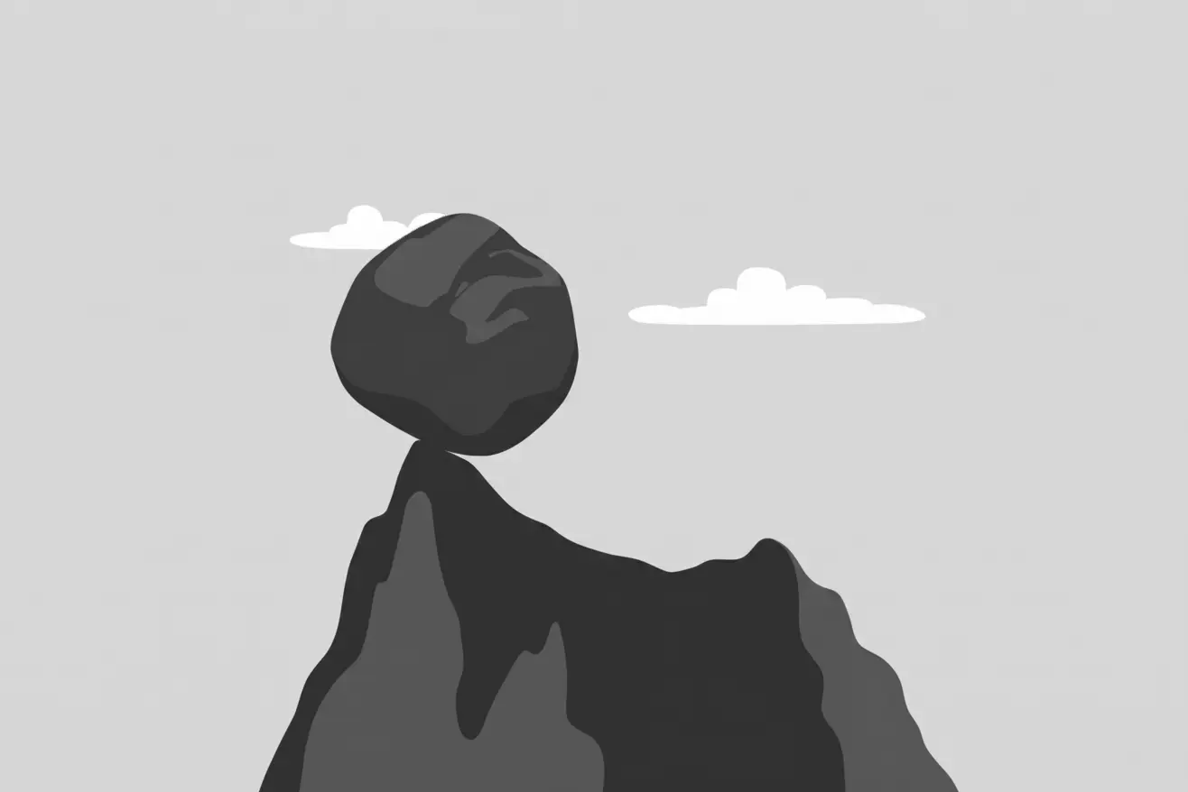 A boulder balanced on a mountain peak